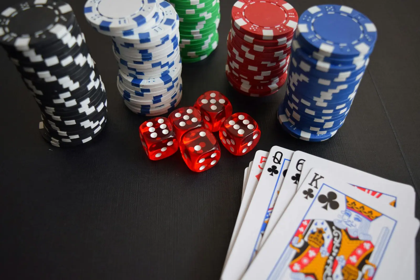Casino chips, dice and playing cards set out on a table