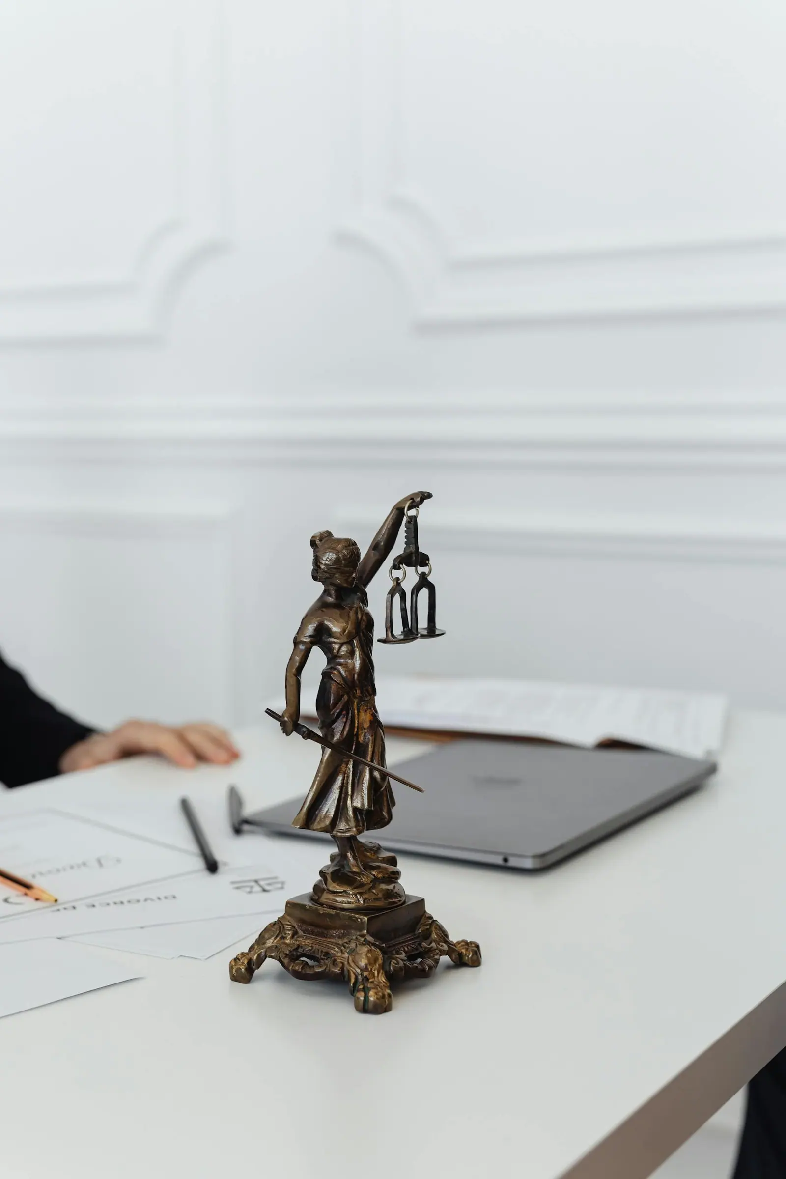 Close up of lady justice statue on a white table in an office setting
