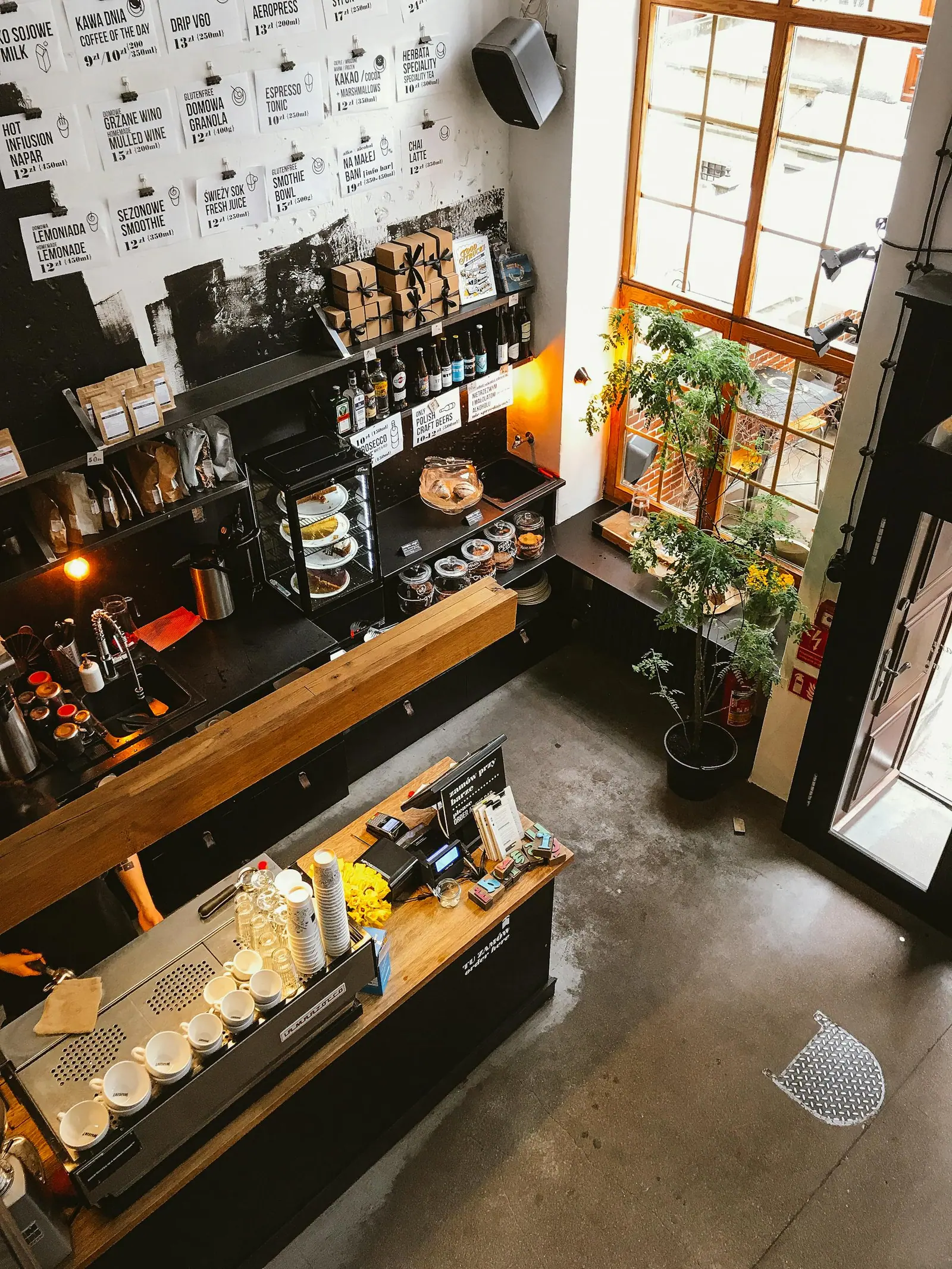 High angle view of a modern coffee shop interior with a wooden counter and cozy furnishings ideal for business and leisure