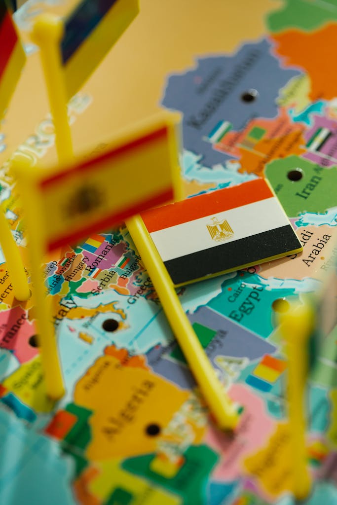Close-up of a vibrant map with miniature flags highlighting countries.